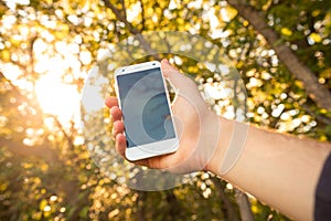 Close up of a man using mobile smart phone outdoor