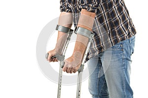 Close up of a man walking with crutches isolated on a white back