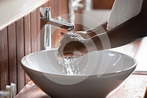 Close up of man wash hands in sink in morning