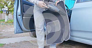 Close up of a man washing a car carpet