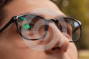 Close-up of man wearing glasses. Brown-eyed guy looking up. Healthy sight concept. Businessman, student in eyewear