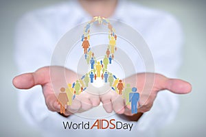 Close-up man in a white shirt holds the AIDS AIDS symbol composed of men and women standing in a row.