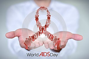 Close-up man in a white shirt holds the AIDS AIDS symbol composed of men and women standing in a row.