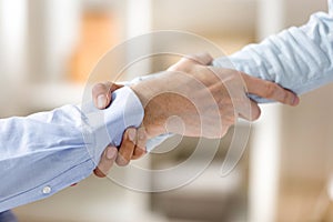 Close up man and woman holding each other wrists, support concep photo