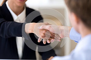 Close up man and woman shaking hands, getting acquaintance, agre