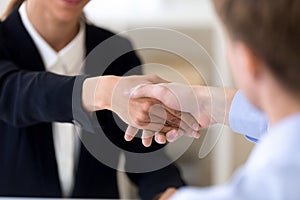 Close up man and woman shaking hands, getting acquaintance, agre photo