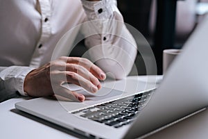 Close-up of man is working typing use laptop computer at home office at the desk.