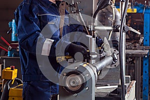 Close-up of a man works with a mettalic hammer