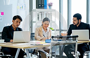 Close up manager discuss with young Asian business man and woman in meeting room of their office with day light