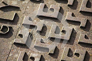 Close up of a manhole cover with `G` and `S` pattern