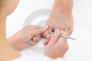 Close-up Of Manicurist Removing Cuticle From The Nails