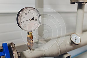 Close up of manometer, pipe, flow meter and faucet valves of heating system in a boiler room.