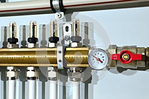 Close up of manometer, pipe, flow meter, water pumps and valves of heating system in a boiler room at home.