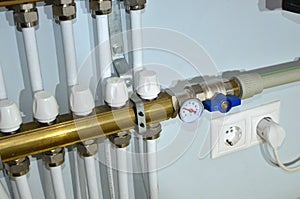 Close up of manometer, pipe, flow meter, water pumps and valves of heating system in a boiler room at home. Systems of water floor