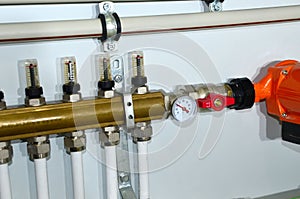 Close up of manometer, pipe, flow meter, water pumps and valves of heating system in a boiler room at home. Systems of water floor