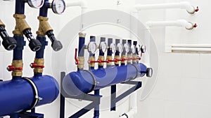 Close up of manometer, pipes and faucet valves of heating system in a new white boiler room. Stock footage. Boiler room