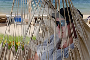 Close-up of a mans face in a hammock.