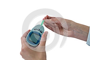 Close-up of mans hand testing blood sugar with glucometer