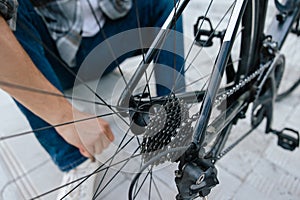 Close up of mans hands fixing a problem with bike tire
