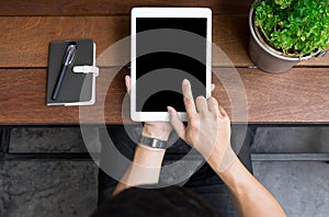 Close up of mans hands using tablet on counter, Image taken from above