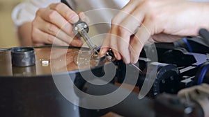 Close up of mans soldering wires of cpu