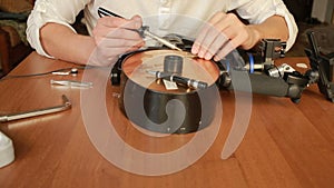 Close up of mans soldering wires of cpu