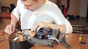 Close up of mans soldering wires of cpu