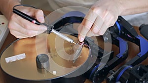 Close up of mans soldering wires of cpu