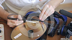 Close up of mans soldering wires of cpu