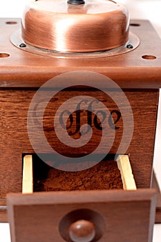 A close up of a manual coffee grinder burr mill machine with catch drawer, conical burr mill and spice hand grinding