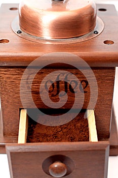 A close up of a manual coffee grinder burr mill machine with catch drawer, conical burr mill and spice hand grinding