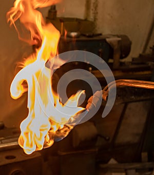 Close up of an manual gas burner flame burns orange