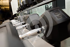 Close up of many dumbbells in sports club or fitness gym for weight training equipment  and exercises