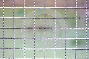 Close up many grid pattern of metal fence