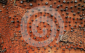 Close up of many nuts on a copper wallboard photo