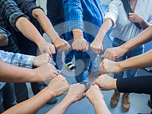 Close-up of many people hands in a circle together with sunlight effect. Concept of teamwork