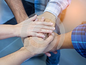 Close-up of many people hands in a circle together with sunlight effect. Concept of teamwork