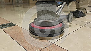 Close up of marble floor polishing with a professional floor scrubber in office building lobby