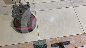 Close up of marble floor polishing with a professional floor scrubber and wet vacuum cleaner in office building lobby