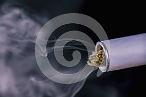 Close up of marijuana joint tip and smoke