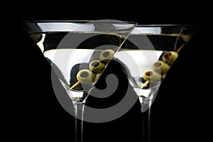 Close up Martini cocktails with olives isolated on black