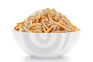 Close up of Marwadi Bhujiya Indian namkeen snacks on a ceramic white bowl.