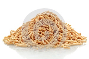 Close-up of Marwadi Bhujiya Indian namkeen snacks,  Indian spicy snacks Namkeen, in a pile or heap, isolated over white
