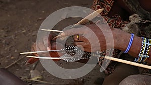 Close-up of Masai men sharpening weapons. close-up