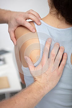 close up massager hands massage shoulder