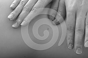 Close up of masseur hands; monochrome