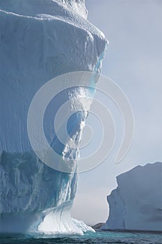 Close up of massive iceberg against morning sky