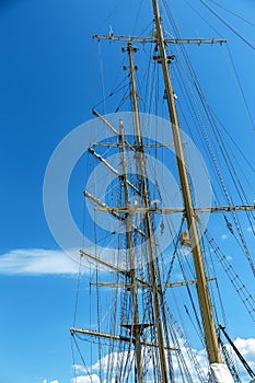 Close-up of a mast on traditional sailboats. The mast of large wooden ship. Beautiful travel picture with masts and rigging of