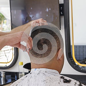 Close-up, master hairdresser does haircut and style with scissors and comb. Concept Barbershop