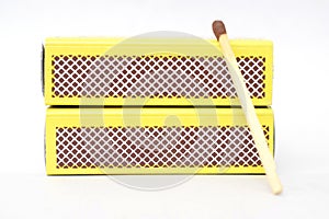 Close up of a matchbox and a fire stick with white background.
